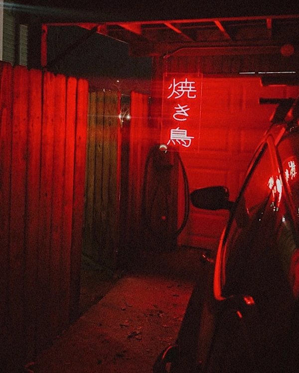 A red lit sign that says yakitori in japanese