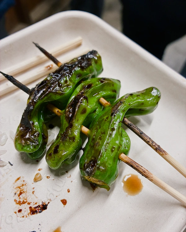 Three grilled peppers on skewers