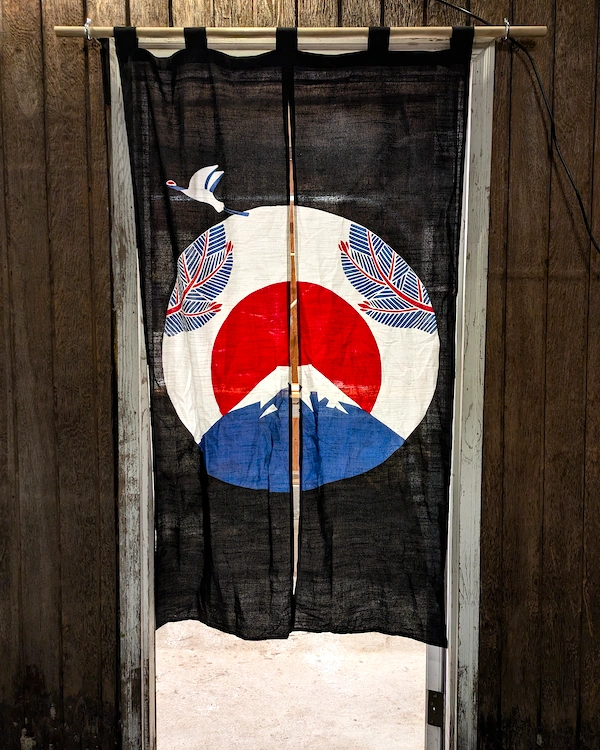 A japanese curtain hanging in a doorway