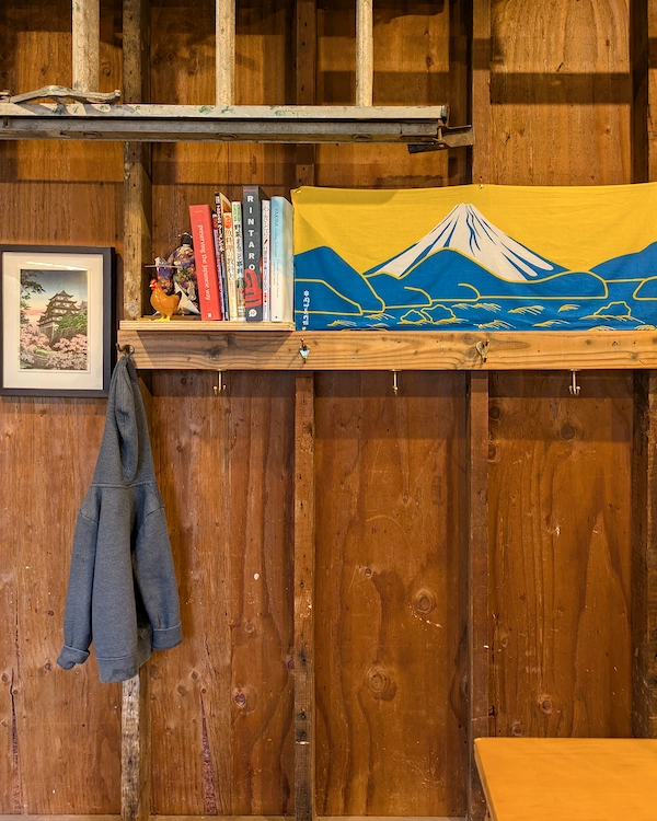 A hoodie on a coat hook with a picture of Mt. Fuji